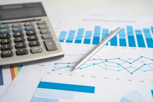 Calculator on chart and graph spreadsheet paper. Finance development, Banking Account, Statistics, Investment Analytic research data economy, Stock exchange trading, Business company concept. photo