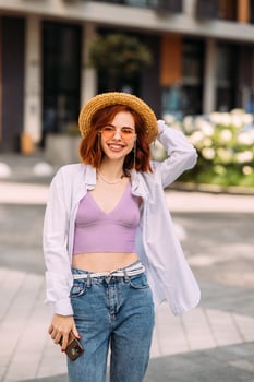 A red-haired woman poses for the camera photo