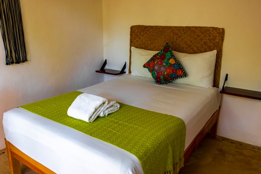 Clean white hotel resort room with green accessories Holbox Mexico. photo