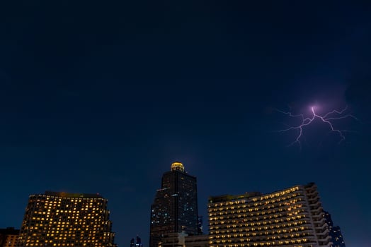 lightning strike over building area in Bangkok City at night, Thailand. photo