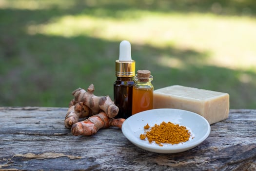 Turmeric, essential oil,bar soap on wooden background. spa concept. photo