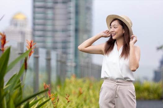 Asian woman tourist enjoying her rooftop panoramic view with cityscape background for vacation and travel concept photo