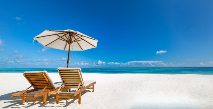 Beautiful tropical beach banner. White sand and coco palms and beach chairs as wide panorama background concept. Amazing beach landscape, romantic scene for couple or honeymoon travel destinations photo
