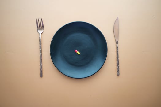 top view of a single capsule on a plate on table photo