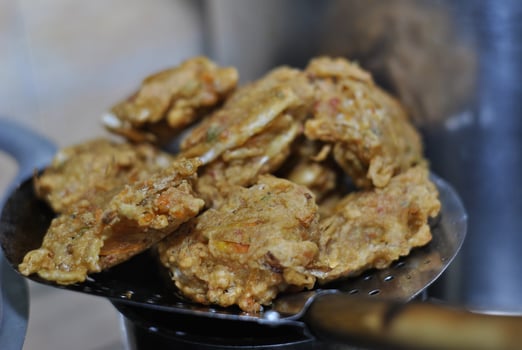 Bakwan is typical traditional snacks of Asian Indonesian people. The ingredients are vegetables, usually, shredded cabbages and carrots, battered and deep fried in cooking oil. photo