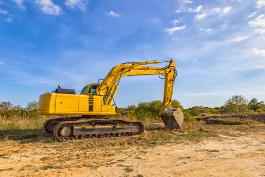 A stopping yellow excavator after work photo