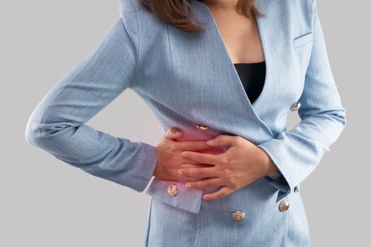 Businesswoman with pain in back. on a gray background photo
