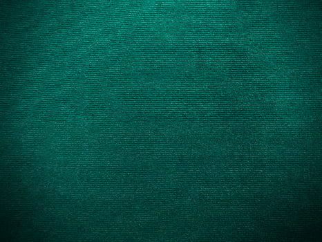Dark green new velvet fabric texture used as background. Empty green fabric background of soft and smooth textile material. There is space for text.. photo