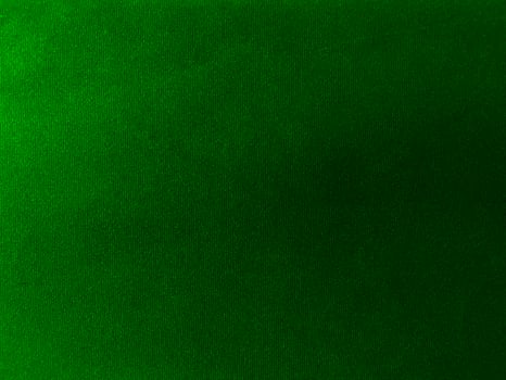 Dark green velvet fabric texture used as background. Empty green fabric background of soft and smooth textile material. There is space for text. photo