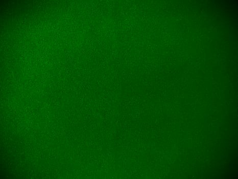 Dark green velvet fabric texture used as background. Empty green fabric background of soft and smooth textile material. There is space for text. photo