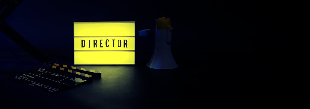 Director chair with cinema lightbox sign Director text on it and clapperboard megaphone photo