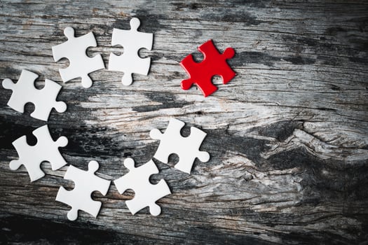 White details of jigsaw puzzle piece on wooden background. Concept of working together as a business team. The idea of getting involved, working for success. photo