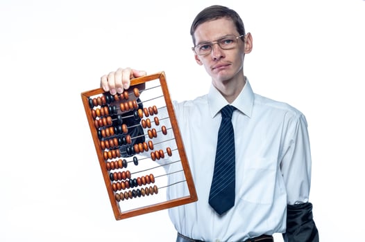 Business man in tie and glasses with bills in hand on white, isolated background photo