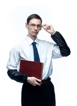 A business man in a tie and glasses with a magazine in his hands on a white, isolated background photo