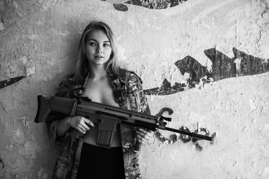 Beautiful portrait of a girl holding a gun photo