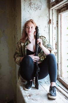 Beautiful portrait of a girl holding a gun photo