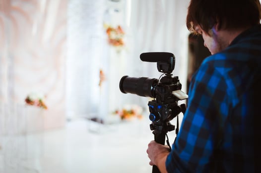 Videographer shoots a video report photo