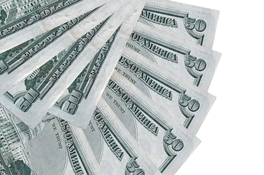 50 US dollars bills lies isolated on white background with copy space stacked in fan shape close up photo