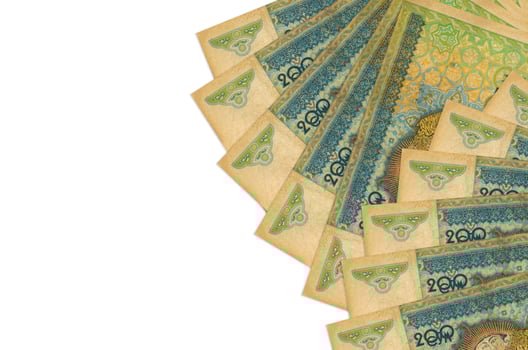 200 Uzbekistani som bills lies isolated on white background with copy space. Rich life conceptual background photo