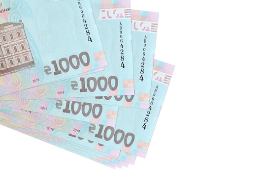 1000 Ukrainian hryvnias bills lies in small bunch or pack isolated on white. Mockup with copy space. Business and currency exchange photo