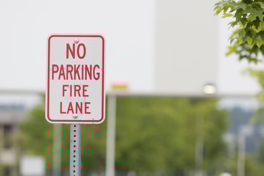 No parking fire lane sign close before a bridge photo