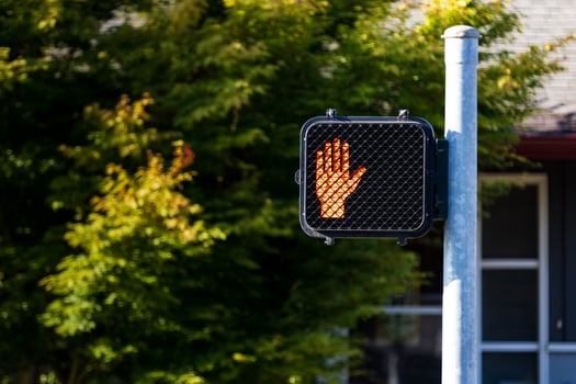 Crosswalk hand symbol sign on a post photo