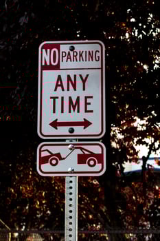No parking any time tow away zone sign on a post photo