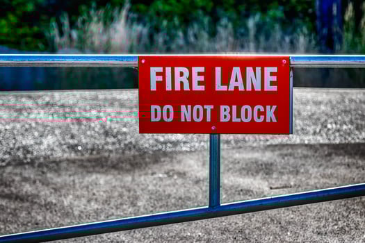 Fire lane do not block sign on a fence photo