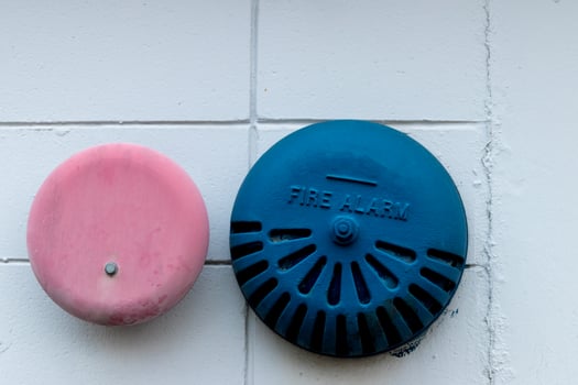 Abstract building wall with antique fire alarms photo