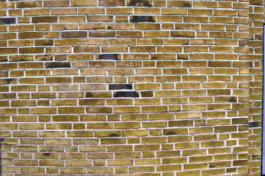 Detailed view at a colorful old and weathered brick wall texture as a panoramic background. photo