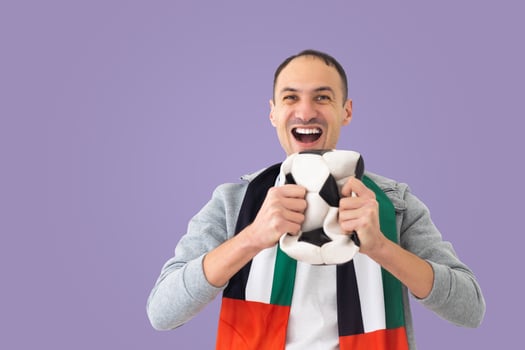 male football fan with a crumpled ball and with the UAE flag photo