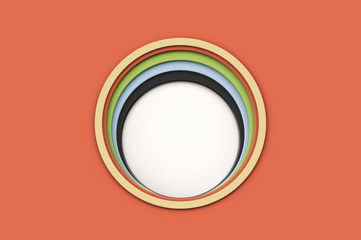 Colorful paper cut round holes. Stacks of paper that have been cut into circles are arranged in size order, smallest to largest. photo