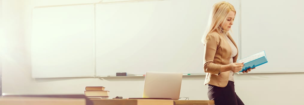 Portrait of happy teacher in classroom photo