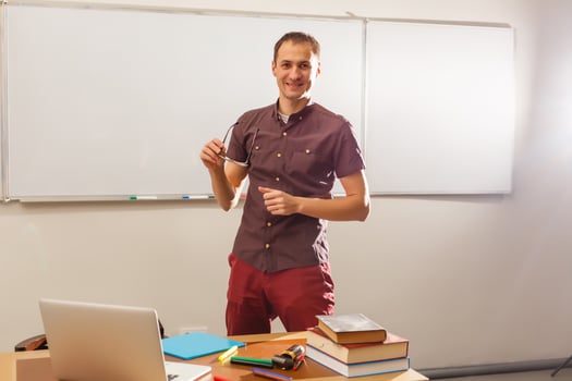 Male teacher listening to students at adult education class photo