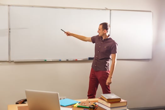 Male teacher listening to students at adult education class photo