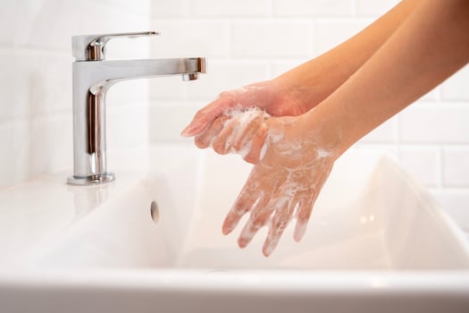 Woman washing her hands  in the bathroom at home photo