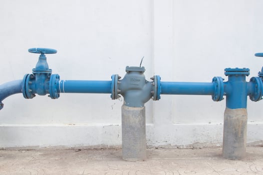 Large water supply valve with a white background of the cement wall photo