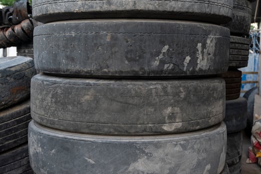 Old broken car tires stacked photo