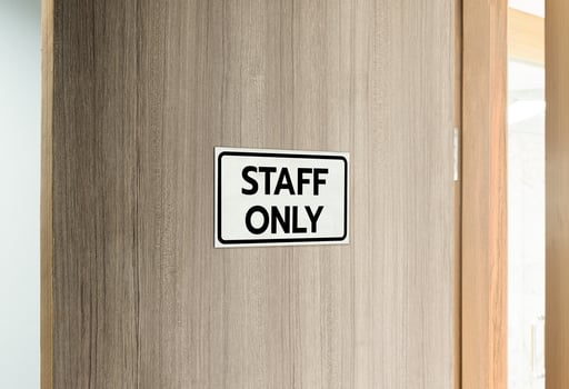 Warning silver stainless steel sign with character black message staff only in front of the wooden door photo