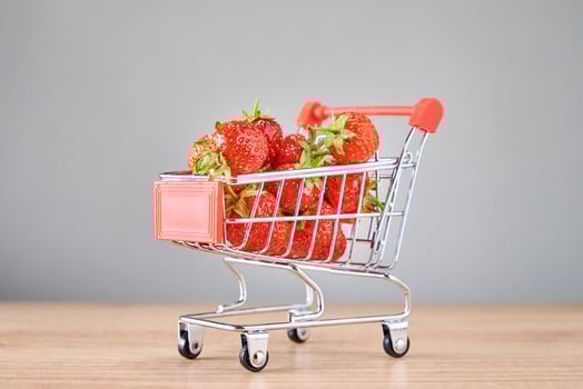 Fresh strawberry in small shopping cart photo
