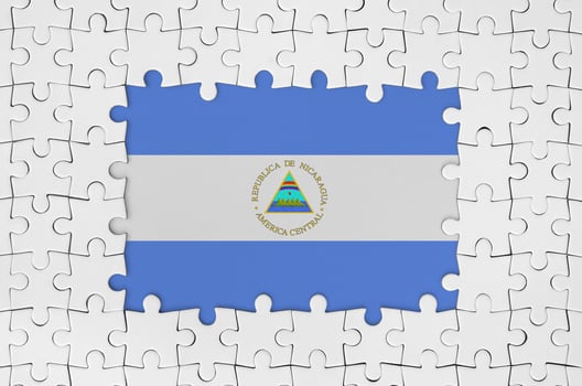 Nicaragua flag in frame of white puzzle pieces with missing central part photo