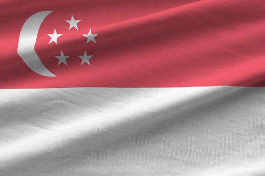 Singapore flag with big folds waving close up under the studio light indoors. The official symbols and colors in banner photo