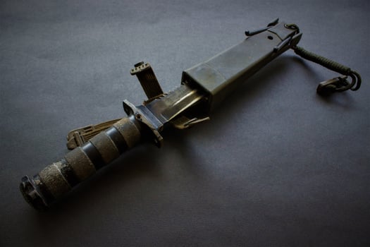 dark black military knife on black background photo