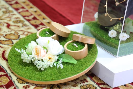 pair wedding ring with rose decoration on a velvet carpet photo