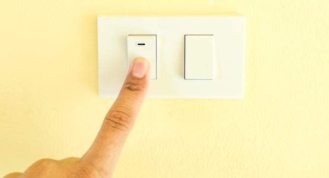 White light switch, finger press on off, the concept of saving electricity, reducing costs. photo
