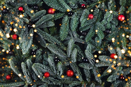 Christmas background with fir branches and red and black balls. photo
