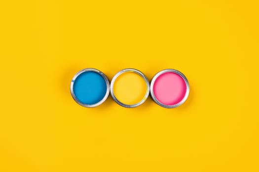 Colored background with paint jars and brushes. photo