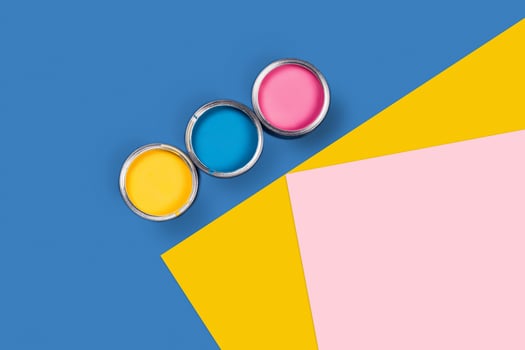 Three-colored background with paint jars. photo