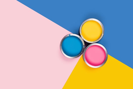 Three-colored background with paint jars. photo