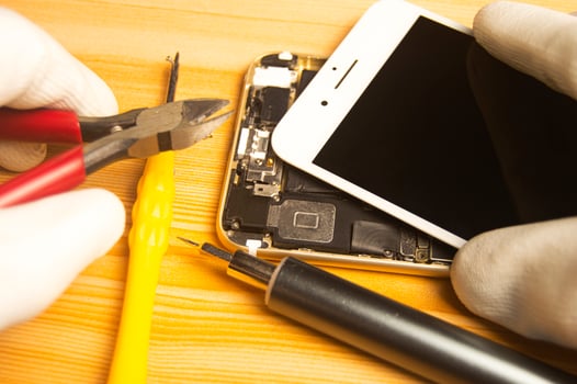 Top view of a technician repairing a smartphone photo